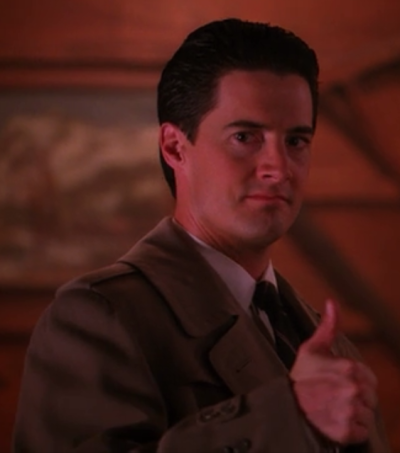 Dale Cooper in Episode 16 gives a thumbs up after having figured out the identity of Laura's killer after experiencing visions.